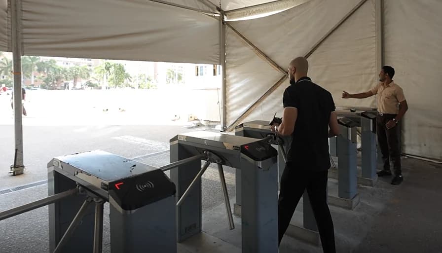 A visitor passing a turnstile